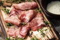 Delicious pork bacon sliced Ã¢â¬â¹Ã¢â¬â¹into strips on a wooden background with spices and fresh thyme. A serving of low-fat succulent